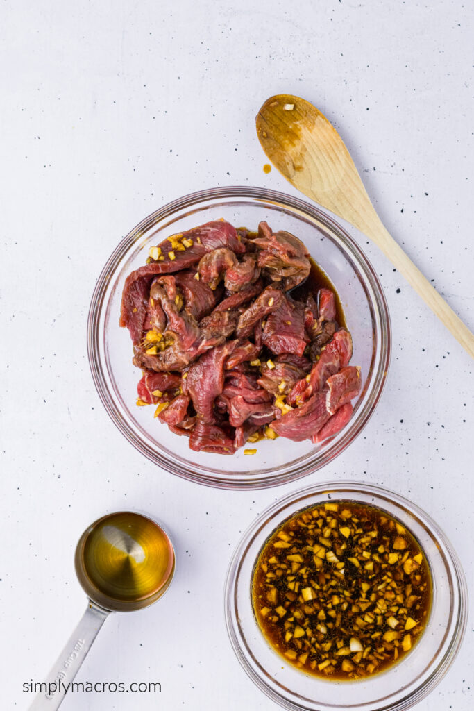 Beef being marinated in a bowl. 