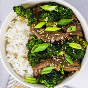 Air fried beef and broccoli in a bowl served over rice.