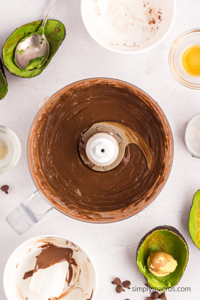 Overhead of avocado chocolate mousse in the food processor, ready to dispense into serving cups. 