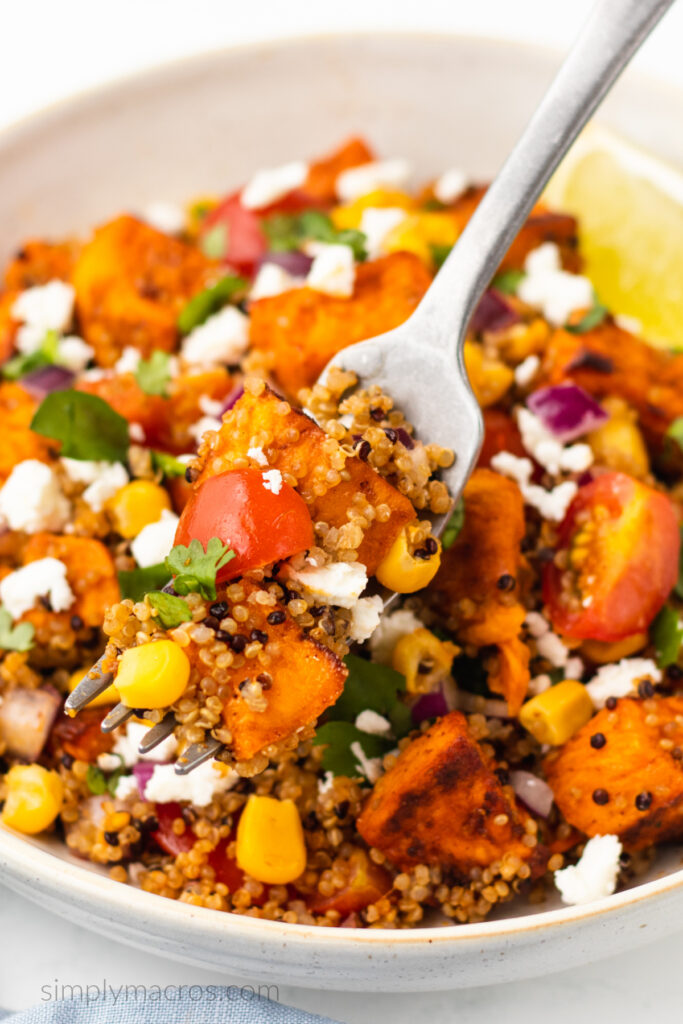 Close up of a fork bite shot of a quinoa sweet potato bowl. 