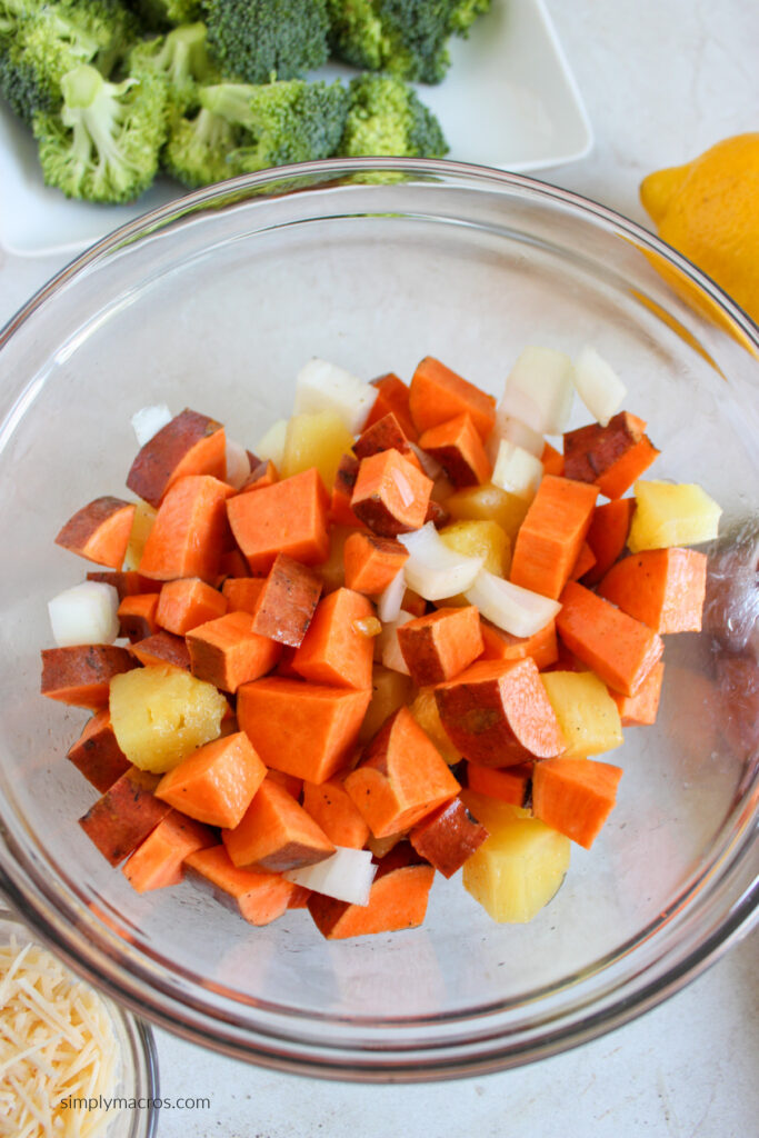 Mixing bowl with diced sweet potatoes, pineapple, and onion. Mixed with olive oil, salt and pepper. 