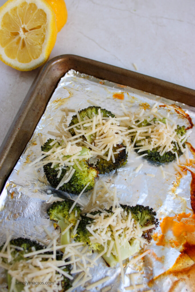 Cooked broccoli that's been smashed and topped with parmesan cheese. 