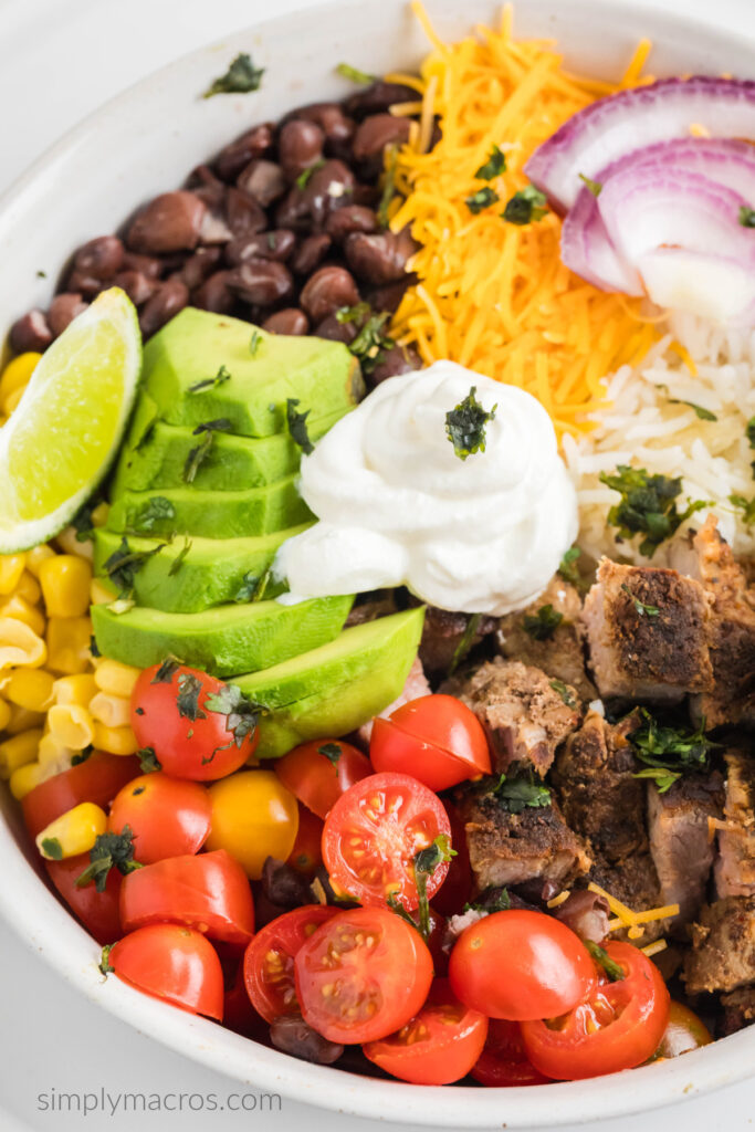 Close up of steak burrito bowl in a white bowl, ready to eat. 