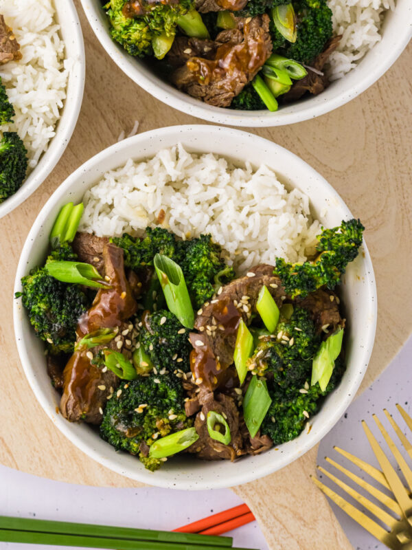 Air fryer beef and broccoli served over a bowl of rice.