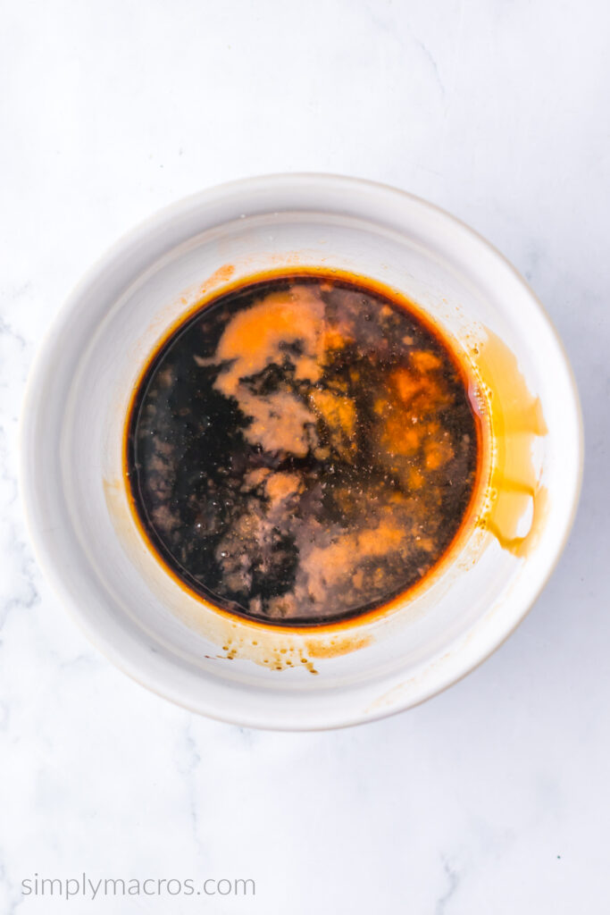 Combined sauces and seasonings in a bowl on a white table top. 