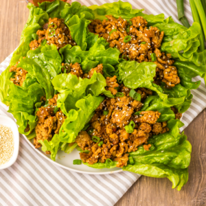 Copycat PF Chang's chicken lettuce wraps made in the slow cooker, served on a white plate.