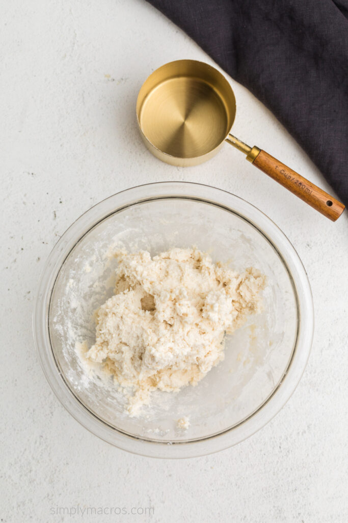 cottage cheese and flour mixed to create a dough, in a bowl. 