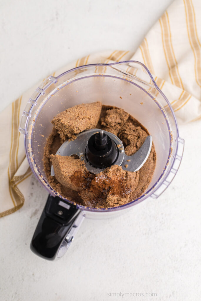 Almonds that have been in the food processor for about 4 minutes, topped with cinnamon and salt. Ready to finish processing. 