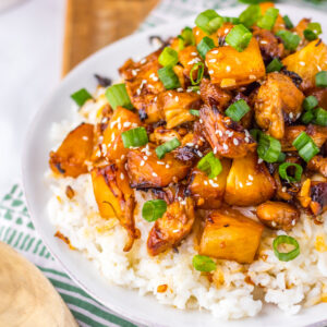 Overhead shot of brown sugar pineapple chicken bites over a bed of rice.