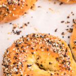 3 ingredient cottage cheese bagels on a baking sheet, ready to serve. Pinnable image.