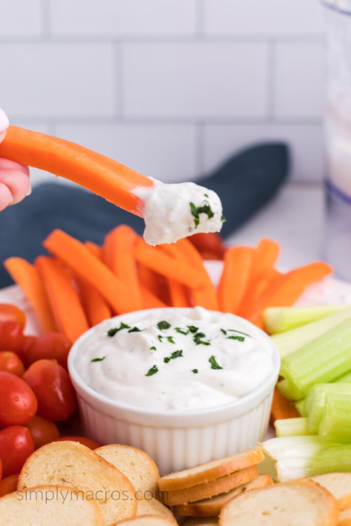 Cottage cheese ranch dip on a carrot stick. Ready to eat.