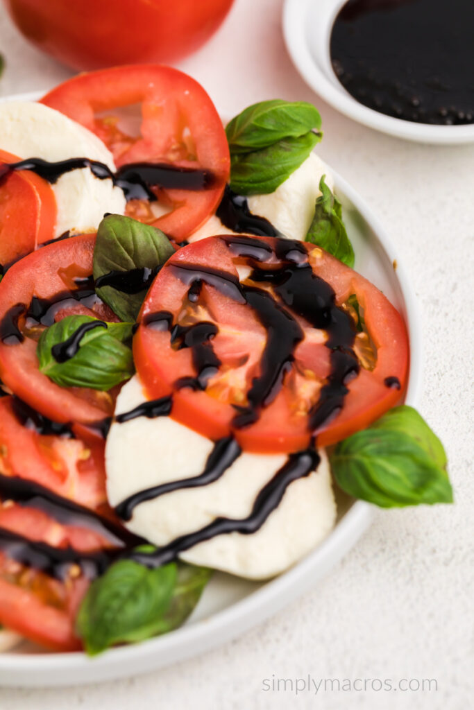 Close up of a caprese salad with a balsamic glaze. 