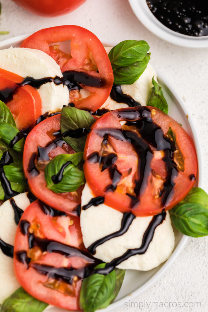 Overhead shot of a caprese salad with balsamic glaze. 