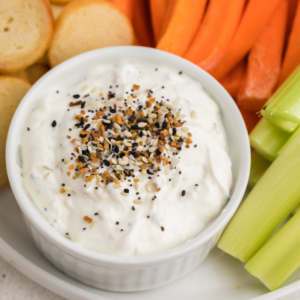 Close up of everything bagel dip with seasoning on top.