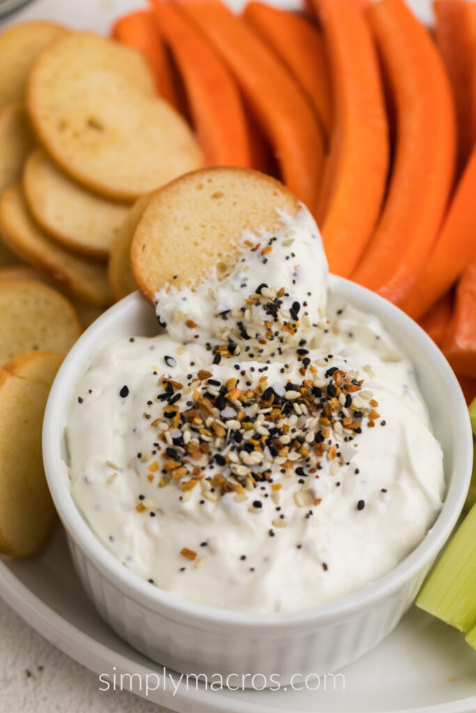 Everything Bagel Dip with a bagel chip dipped in. Ready to serve.