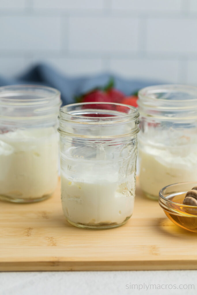 Jars with a bottom layer of Greek yogurt. 