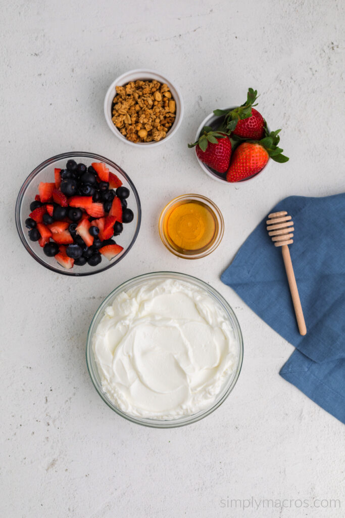 Ingredients needed for Greek Yogurt Parfait on a white table top. 