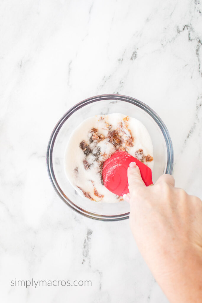 Spatula being used to blend sugar and molasses into brown sugar. 