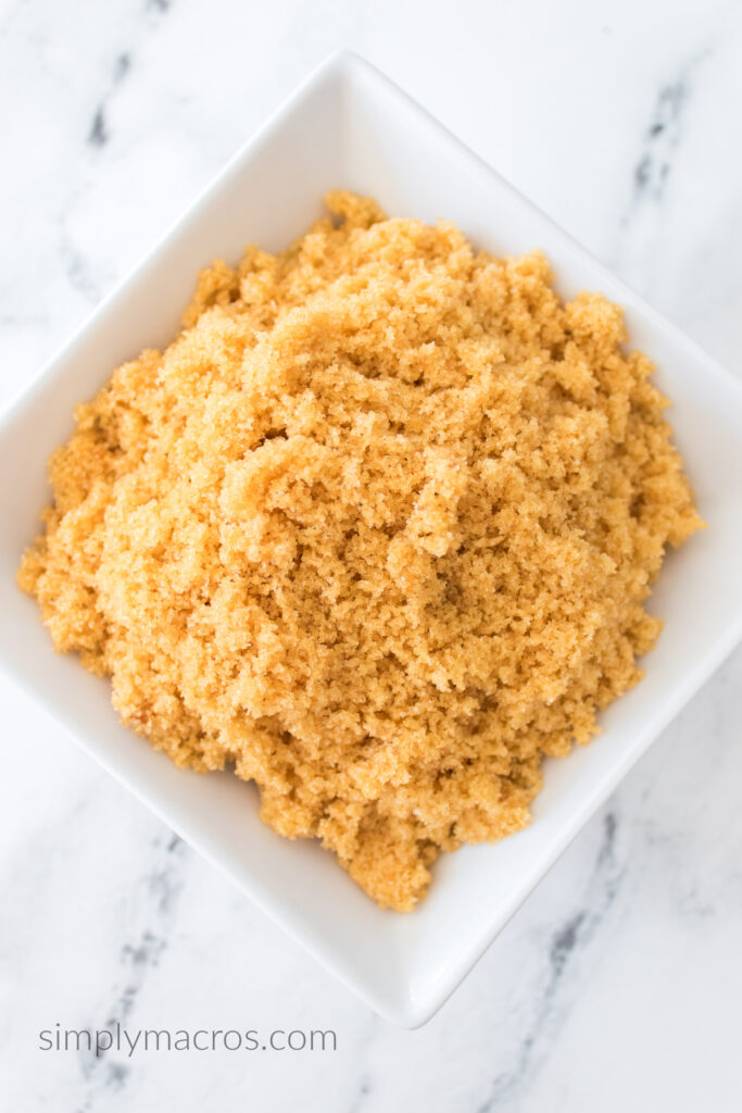 Bowl of brown sugar on a white table. 