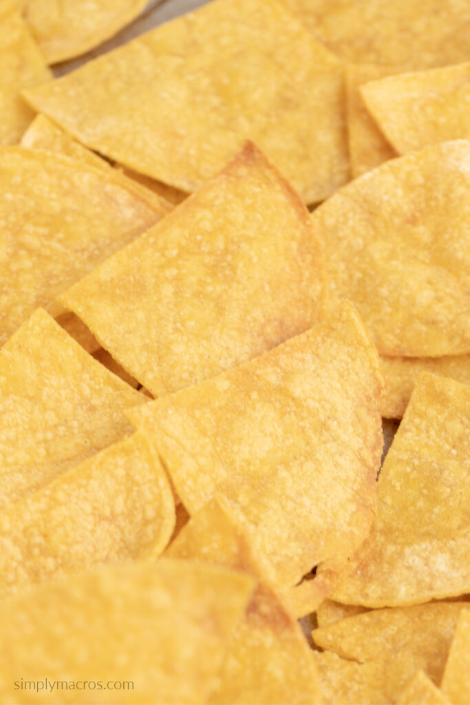 Tortilla chips cooling on the baking sheet so they can crisp up before serving.