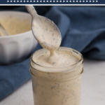 Low calorie ranch dressing being scopped from a jar, pinnable image.