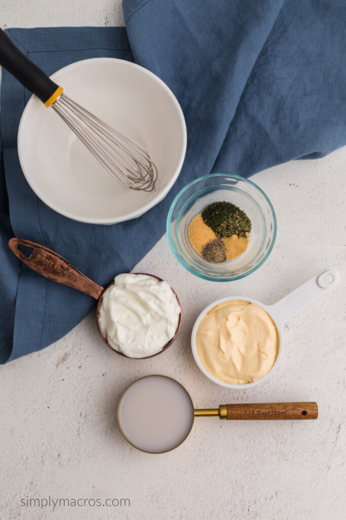 Ingredients needed for low calorie ranch dressing, light mayo, greek yogurt, almond milk, and seasonings. 