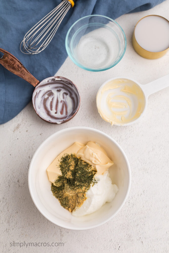 Bowl filled with light mayo, greek yogurt and seasonings. Ready to be whisked into dressing.