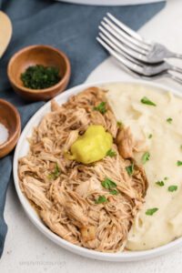 Mississippi chicken served over mashed potatoes.