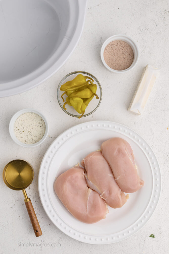 Ingredients needed to make slow cooker Mississippi Chicken on a table top. 