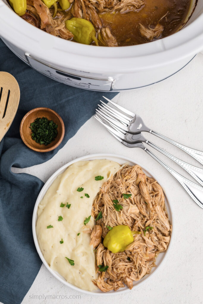 Overhead photo of Mississippi chicken in a plate with mashed potatoes. 