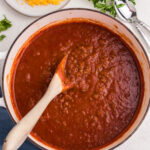 No-bean chili in a large skillet with a wooden spoon.