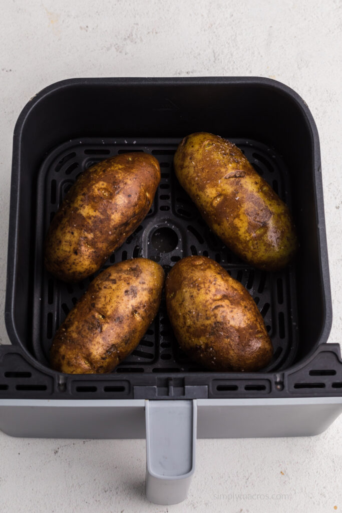 Russet potatoes in air fryer basket ready to cook. 