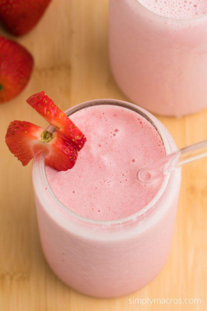 Close up overhead shot looking into the glass of a strawberry flavored cottage cheese smoothie.