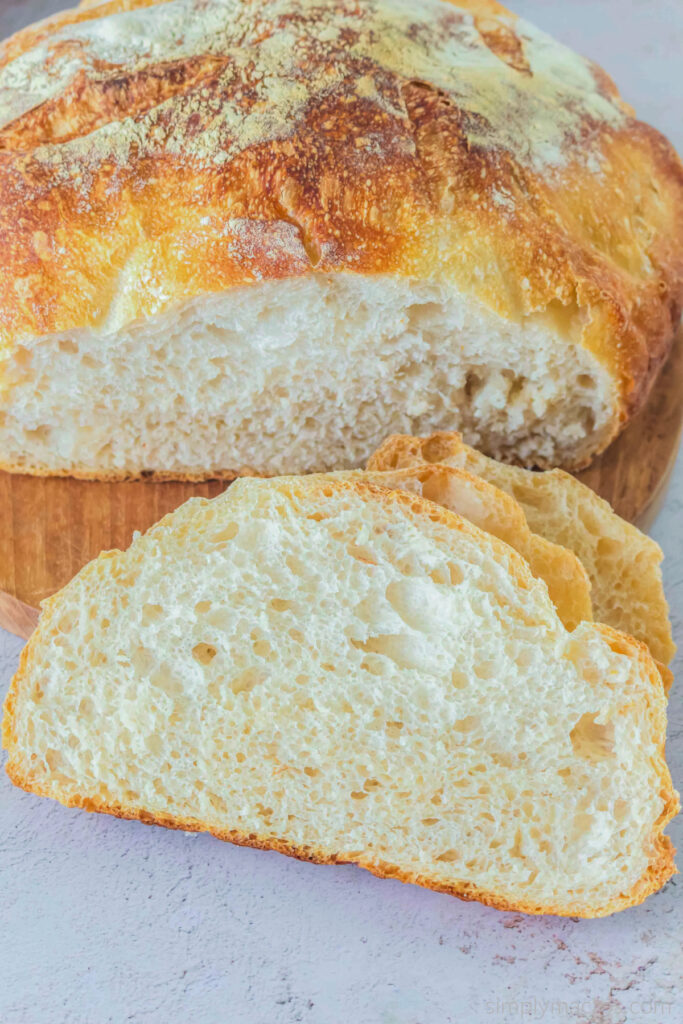 Overhead shot of sourdough bread sliced on a cutting board and ready to serve. 