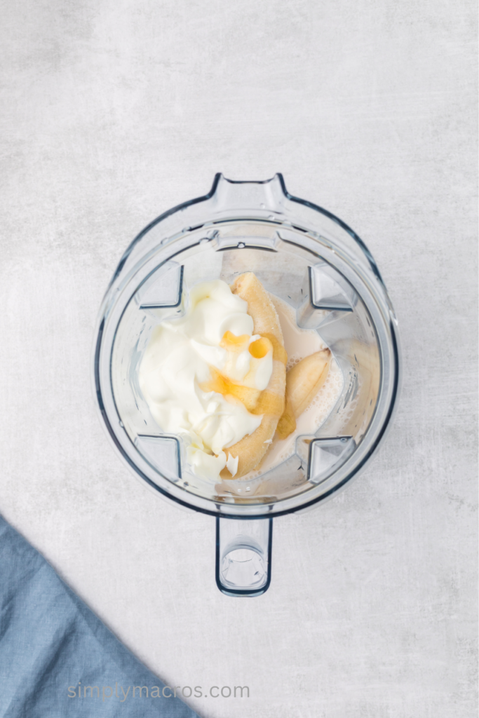Frozen bananas, yogurt, almond milk, and honey in a blender. 