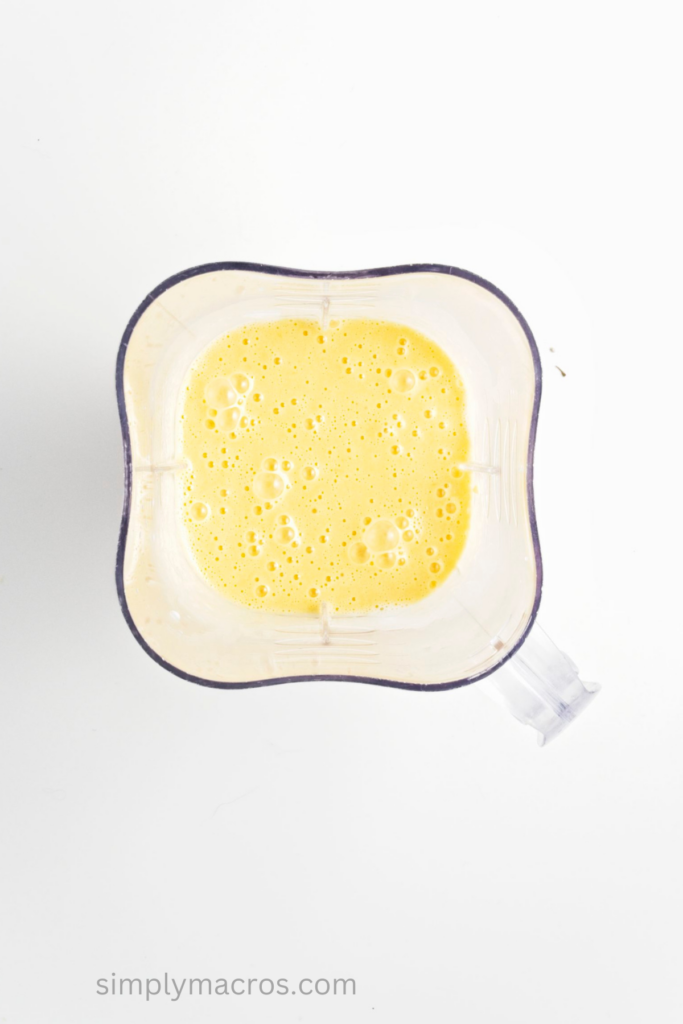 Mangos and coconut milk blended together in the bottom of a blender. 