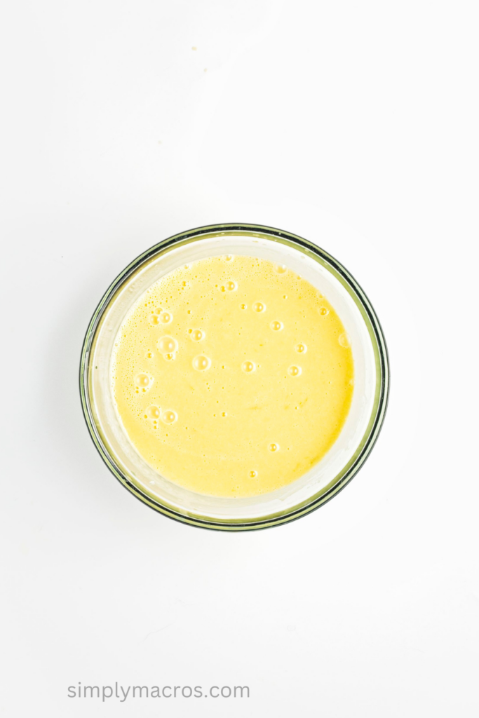 maple syrup, lime juice, and lime zest added to a bowl with the coconut milk and mango mixture. 