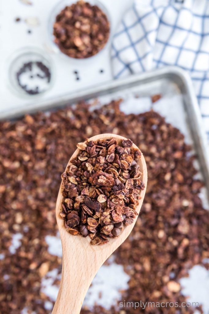 Mocha Almond Gluten Free granola scooped on a spoon, ready to serve.
