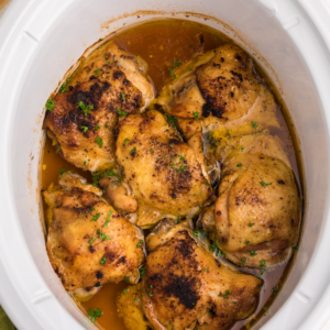 overhead shot of chicken thighs in the slow cooker.