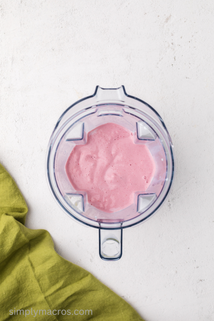 Strawberry banana smoothie in the pitcher of the blender. 