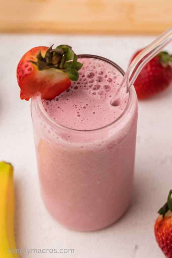 Close up of a strawberry banana smoothie in a glass, ready to drink. 