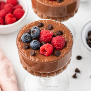 Close up of chocolate flavored chia pudding with fresh berries on top.