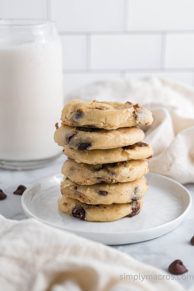 Cottage cheese chocolate chip cookies stacked on a white plate. 