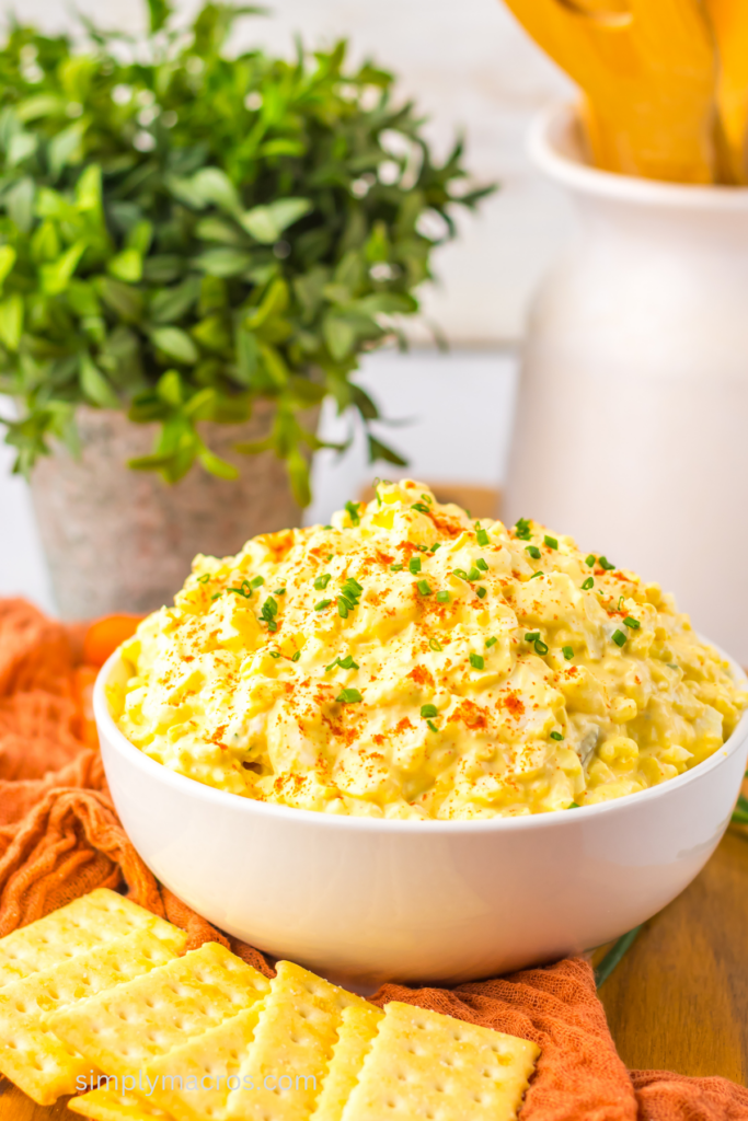 Deviled egg dip in a bowl, served with crackers, ready to eat. 