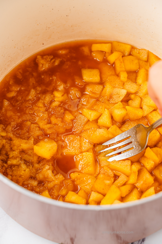 Apples in saucepan, tender and ready to be mashed. 