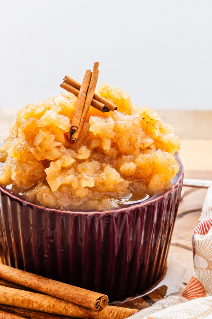 homemade applesauce in a bowl topped with cinnamon sticks. Ready to serve.