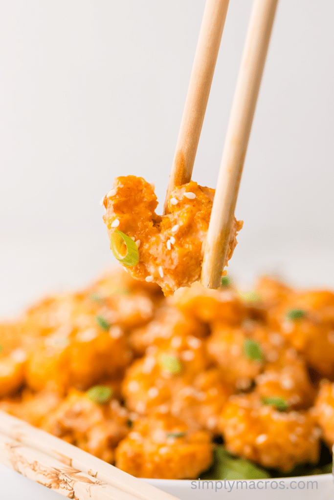 air fried bang bang shrimp being held with chopsticks. 