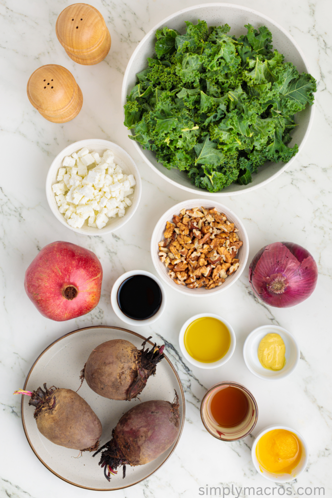 Ingredients separated and measured on a table to make a beet and kale salad. 