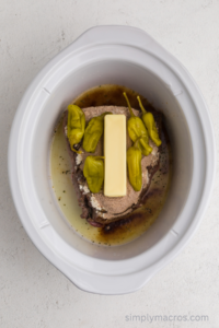 peppers and butter layered onto the roast.