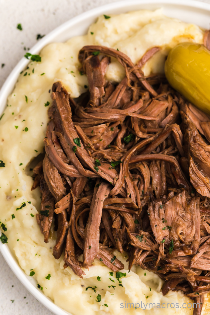 Shredded pot roast over a bed of mashed potatoes. 